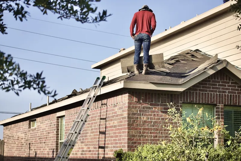 Professional roofer working on a residential roof in Downtown New Haven